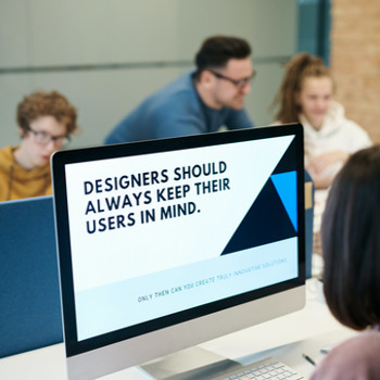 Computer with words on screen that read, "Designer should always keep their users in mind."